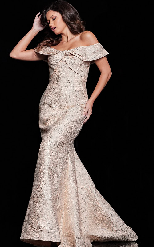Model wearing Jovani 37394, beige off-the-shoulder gown from the side.