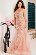 Model wearing Jovani 37412 blush gown with floral background showing elegant design