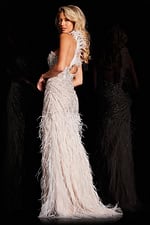 Model wearing Jovani 37442 white gown showcasing open back and feather details, back view.