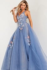 Model wearing Jovani 37468 blue gown with floral appliqués from the front.