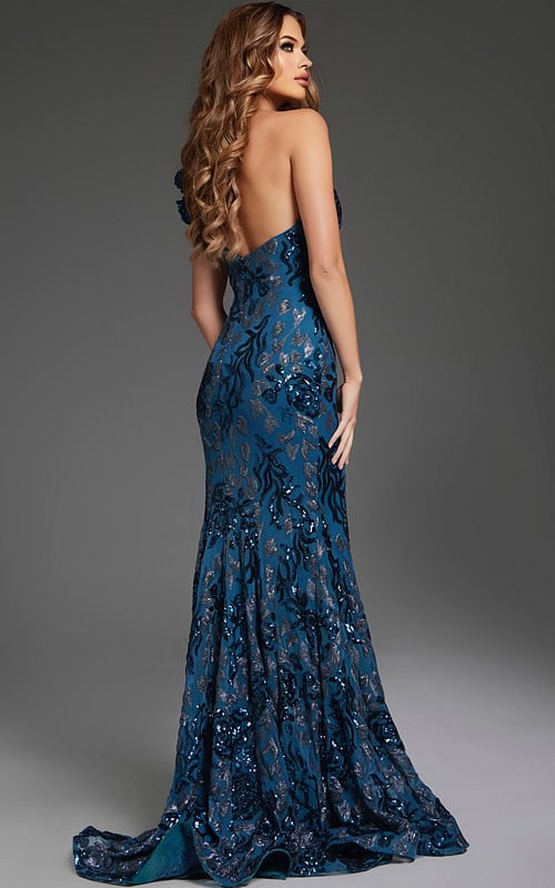 Model wearing Jovani 37634 blue gown with open back and intricate detailing.