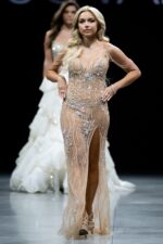 Model wearing 38249 nude gown with embellished details and high slit, front view.