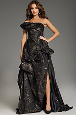 Model wearing Jovani 38265, a brown one-shoulder gown with gold floral accents and a high slit.