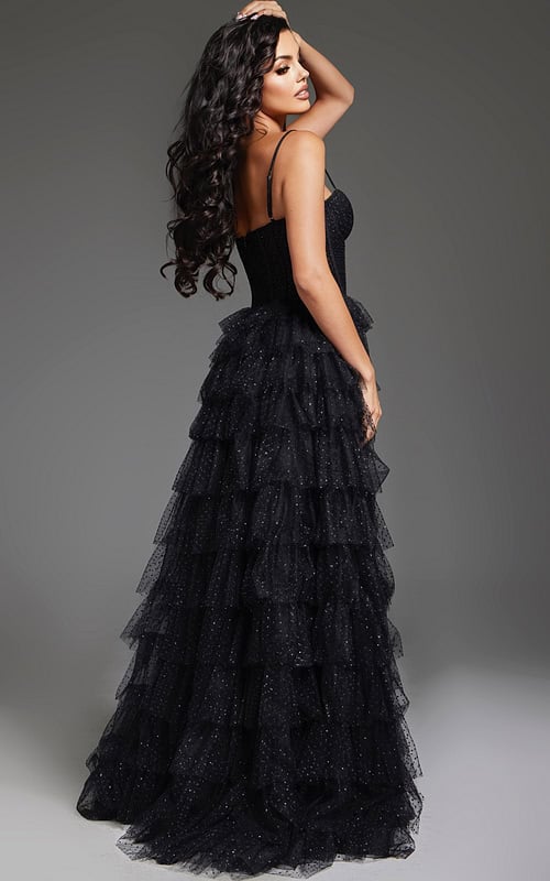 Back view of model wearing Jovani 38278 black evening gown showing tiered ruffle design.
