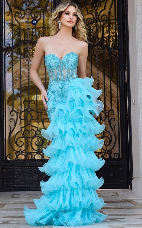 Model wearing Jovani 38295 blue gown with sweetheart neckline and ruffled skirt.