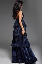model wearing 38296 navy gown, back view showing layered ruffles