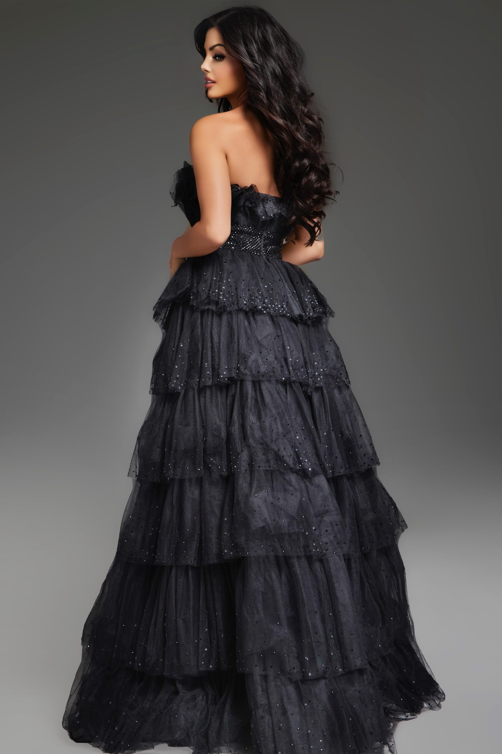 Back view of Jovani 38301 black gown showcasing tiered design.