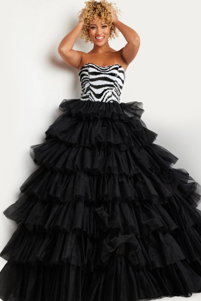 Model wearing Jovani 38360 strapless gown with zebra pattern and layered tulle skirt, front view.