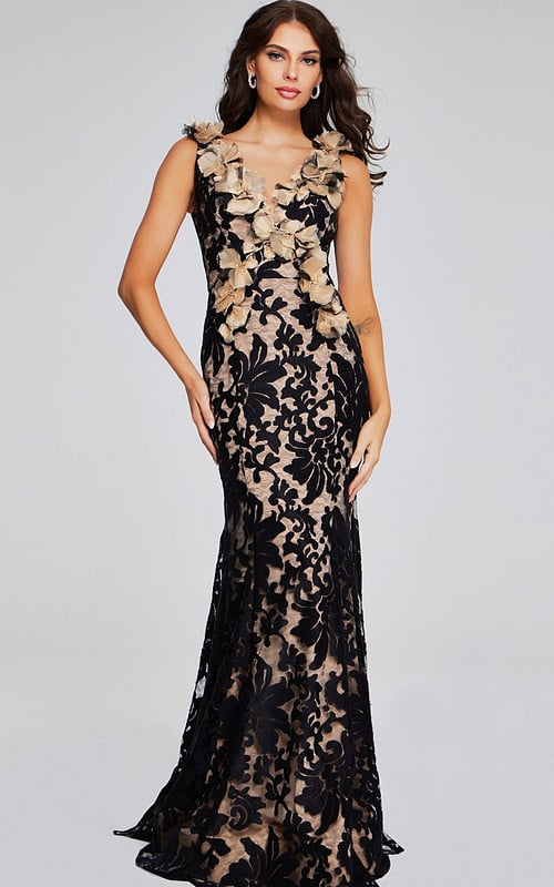 Model wearing Jovani 38497 black lace gown with floral appliqués, front view.