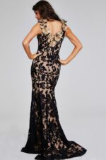Model wearing Jovani 38497 black lace gown, back view with floral detail.