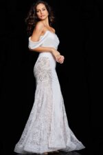 Model in Jovani 38501 ivory dress from a side angle highlighting draped sleeves and beadwork.
