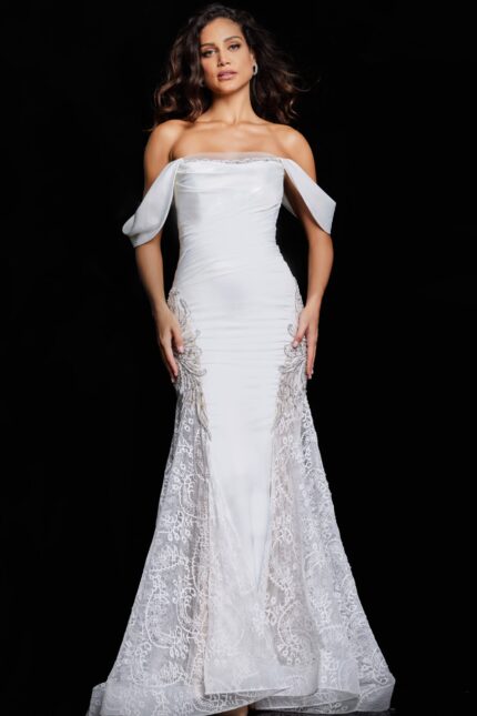 Model wearing Jovani 38501 ivory dress with off-the-shoulder neckline and lace details.
