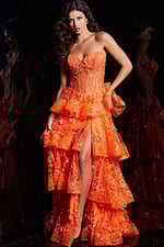 Model wearing Jovani 38528 orange gown with floral embroidery and tiered ruffles from the front