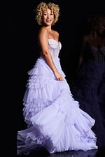 Model wearing Jovani 38539 lilac gown with intricate bodice detail, side view.