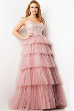 Model wearing Jovani 38577 pink dress with embroidered bodice and tiered layers, front view.