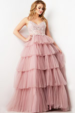 Model wearing Jovani 38577 pink dress featuring tiered tulle skirt and intricate bodice design, front view.