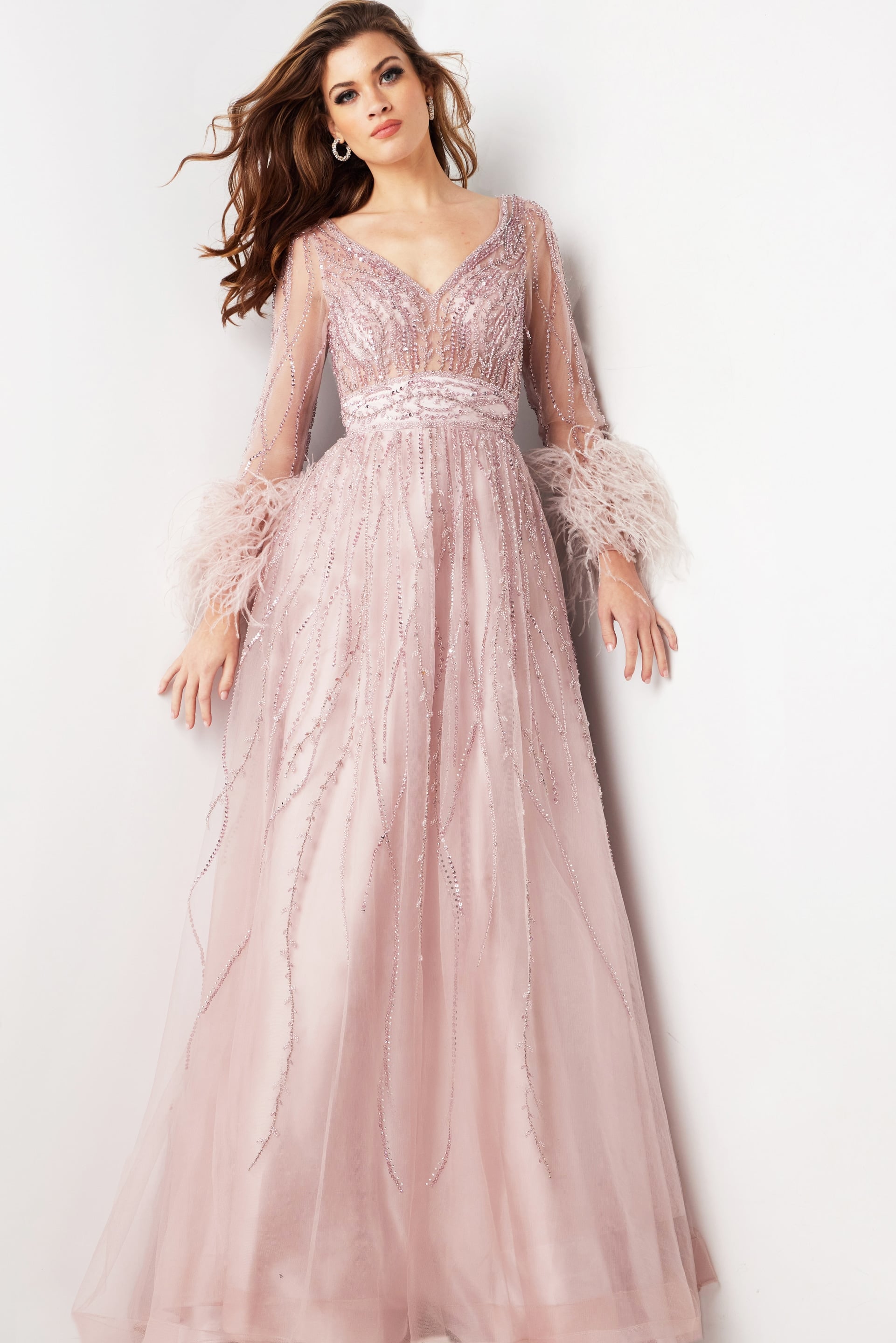 38583-MAUVE-3.jpg Model wearing Jovani 38583 blush gown with V-neckline and beaded details, front view.
