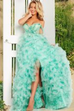 Model in Jovani 38606 gown showcasing tulle layers with green hue and stylish off-the-shoulder design.