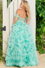 Back view of model in Jovani 38606 gown, showcasing intricate tulle layers in a vibrant green.