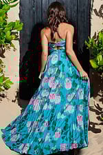 Back view of model wearing Jovani 38638 blue floral dress with cross-back straps.