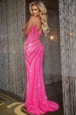 Back view of model wearing Jovani 38707, pink gown with sequined details.