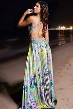 Model in Jovani 38733 displaying the gown's open-back and vivid print design in moonlit setting.
