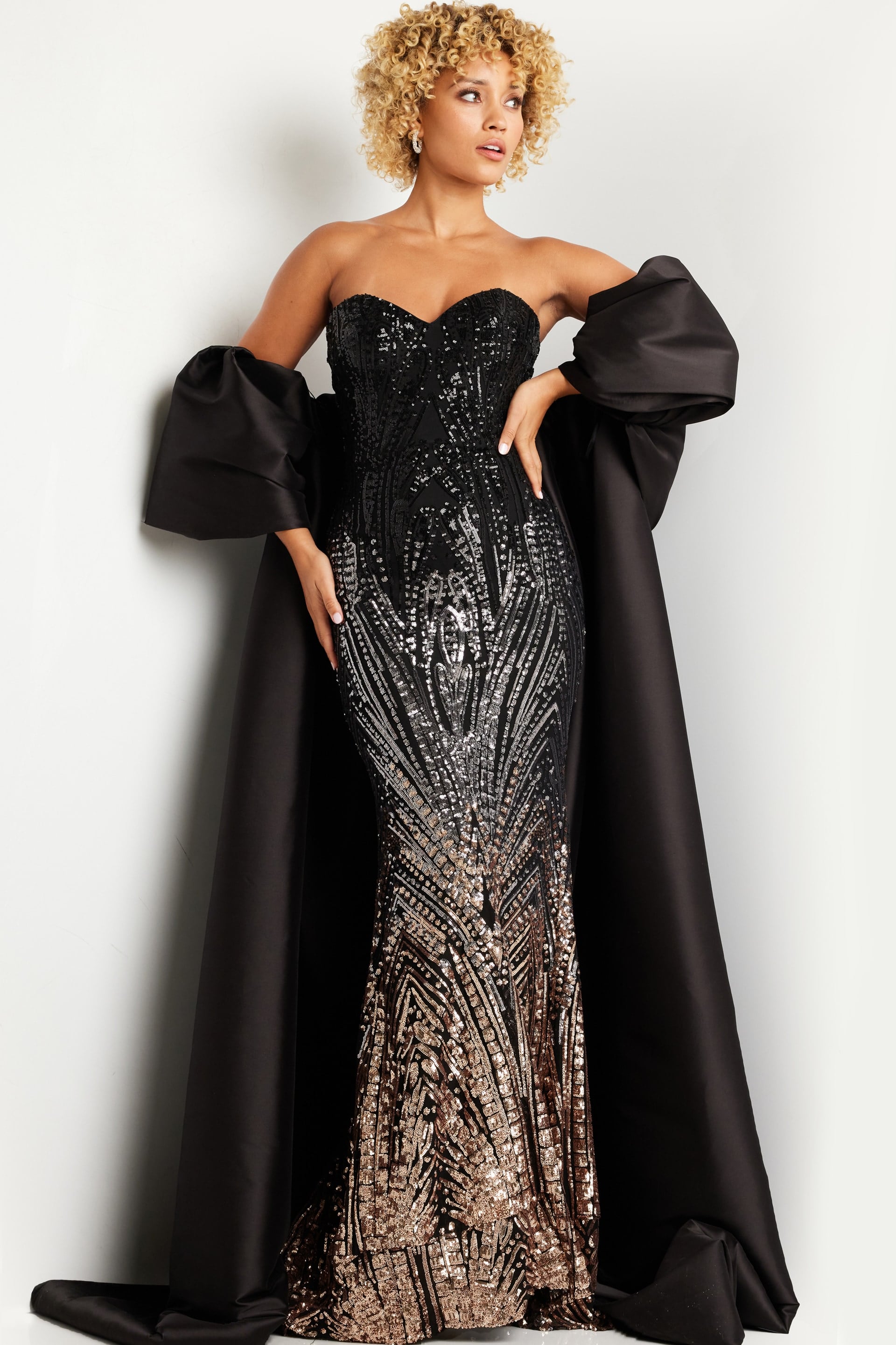 38746_1.jpg model wearing 38746 black gown with sweetheart neckline and detachable sleeves front view