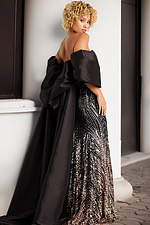 model showing back view of 38746 black gown with bow detail