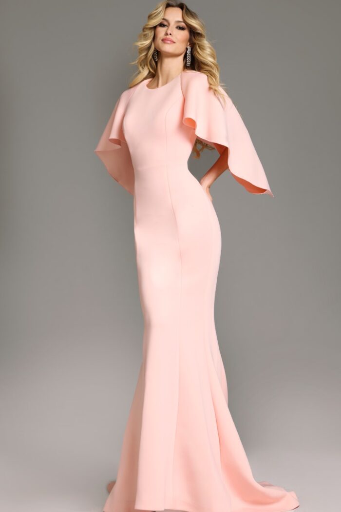 Model in Jovani 38822 blush gown, mermaid silhouette with dramatic sleeves.