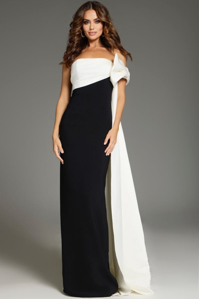 Model wearing Jovani 38864 chic black and white gown with unique shoulder drape