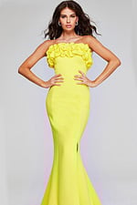 Model wearing Jovani 38922 in yellow, front view, highlighting ruffle detail.