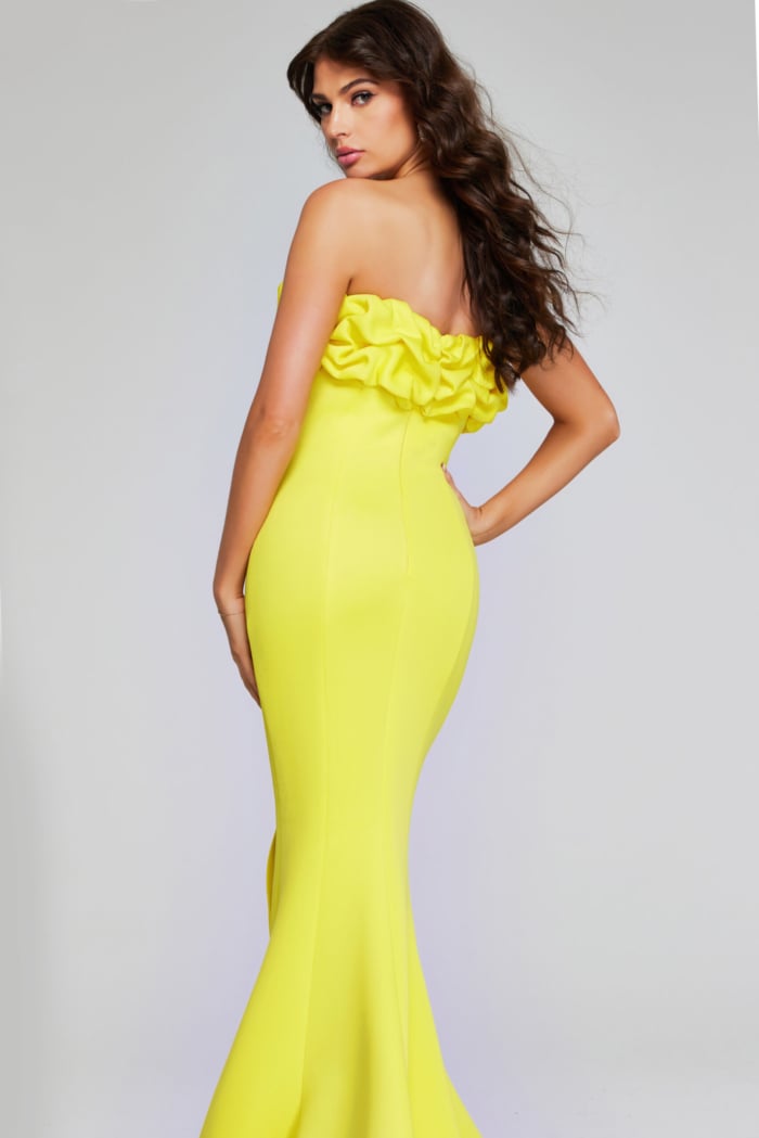 Model wearing Jovani 38922 in yellow, back view, showing the dress's full mermaid silhouette.