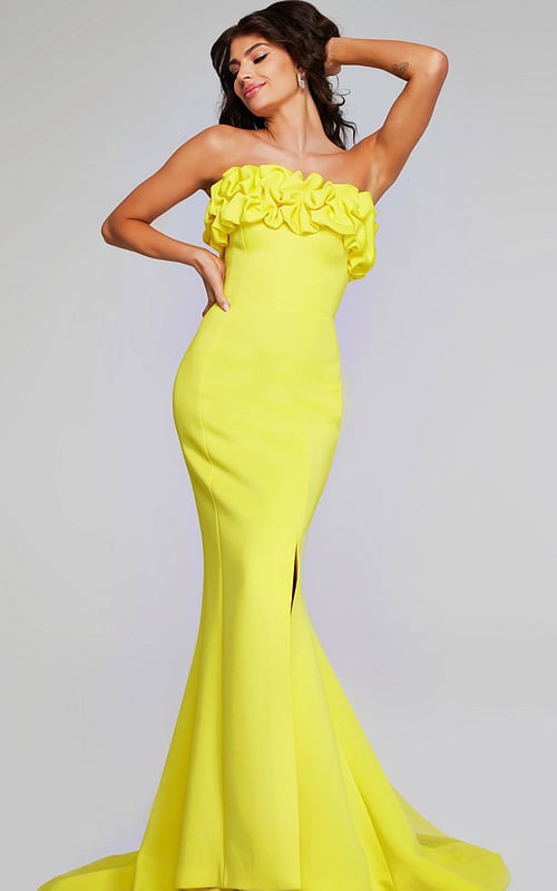 Model wearing Jovani 38922 in yellow, front view with ruffled neckline.