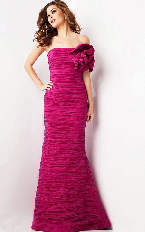 Model wearing Jovani 38947 fuchsia evening gown with strapless neckline and floral shoulder detail.