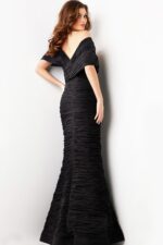 Model displaying the back of Jovani 38954 black gown with mermaid style.
