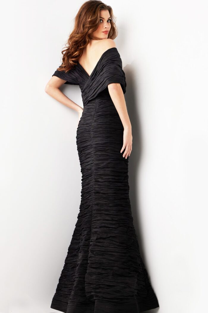 Model displaying the back of Jovani 38954 black gown with mermaid style.