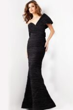 Model in Jovani 38954 black gown, showing the front with elegant neckline.