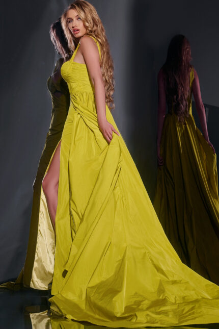 Model wearing Jovani 38957 green dress with sweetheart neckline and high slit, back view.