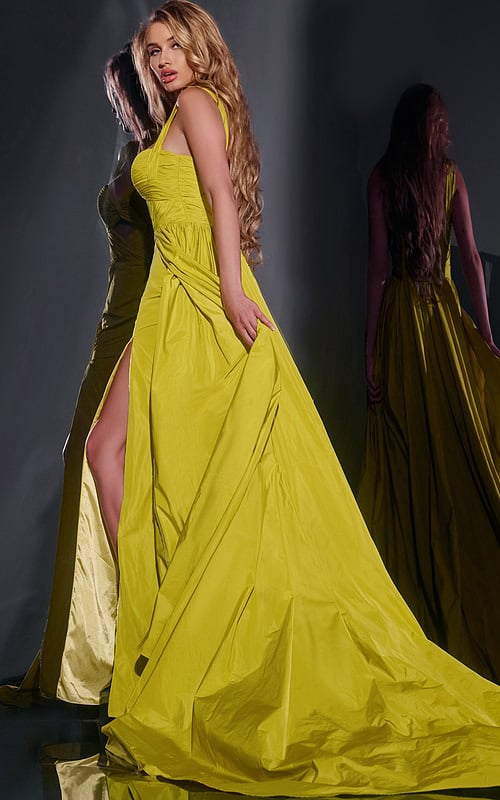 Model wearing Jovani 38957 green dress with sweetheart neckline and high slit, back view.