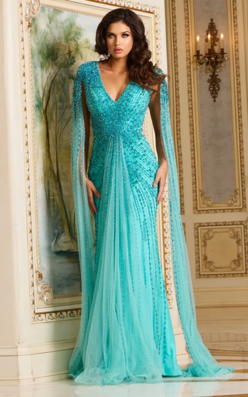 Model wearing Jovani 38964 blue gown with V-neck and beadwork