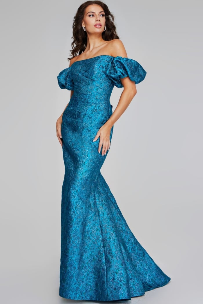 Side-front view of model in Jovani 39113, highlighting the off-the-shoulder design and puffed sleeves.