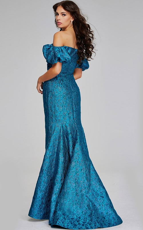 Back view of model wearing Jovani 39113, showcasing the dress's elegant teal fabric and fitted silhouette.