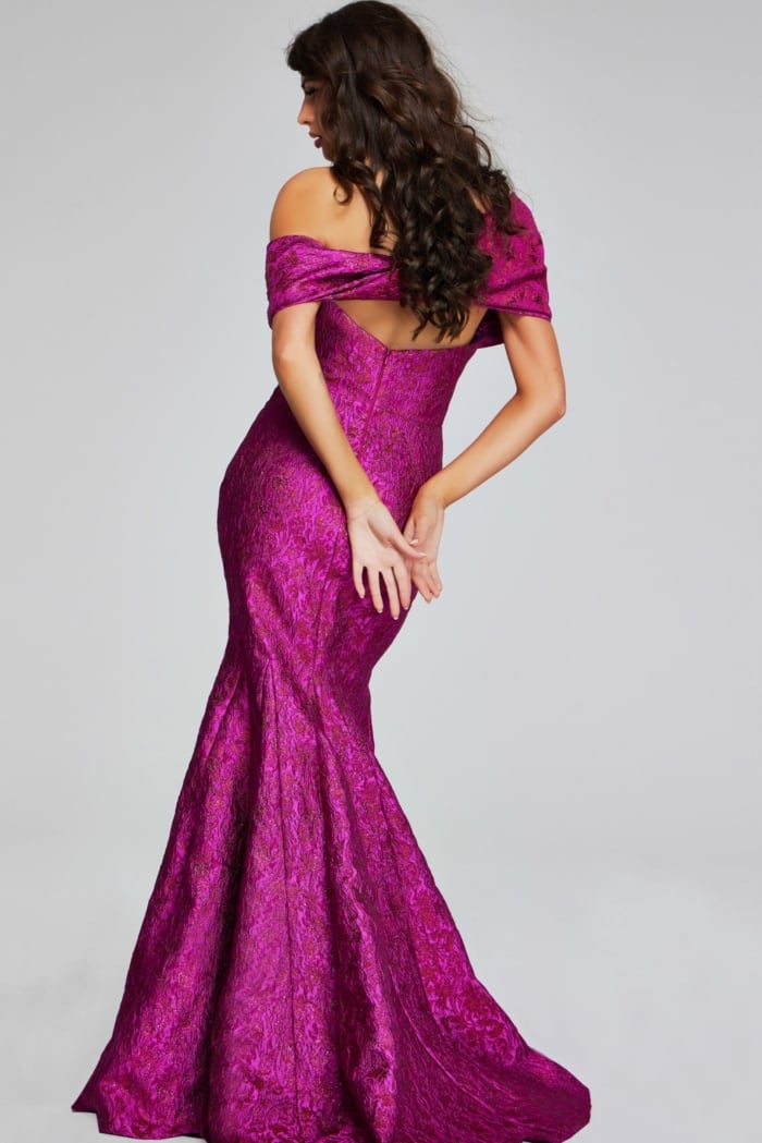 Back view of model wearing Jovani 39114 fuchsia mermaid gown.