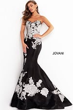 Model wearing Jovani 3917 black gown with silver floral embroidery, another front view.
