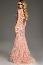 Model wearing Jovani 39174 blush gown with floral embellishments and feathered skirt, back view