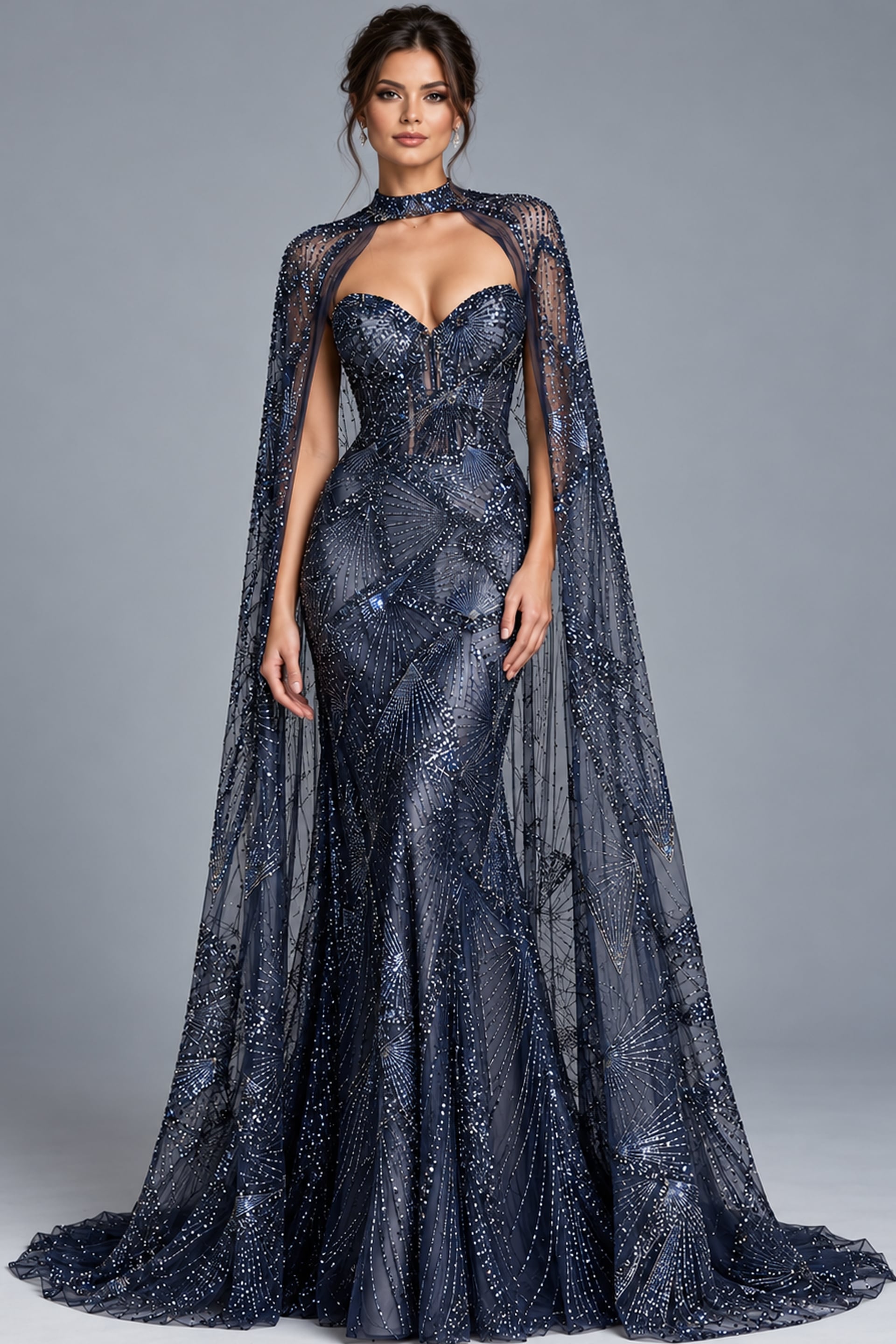 Navy beaded strapless gown with sheer cape shown at an angle