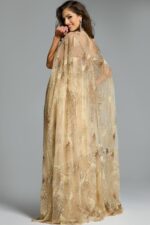 Rear angle of model in gold embellished gown with long glittering cape and allover sequin detailing.