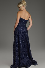 Model wearing Jovani 39224 navy dress with floral lace, back view showing flowing skirt.