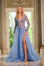Model wearing Jovani 39251 blue gown with deep V-neckline and high slit.