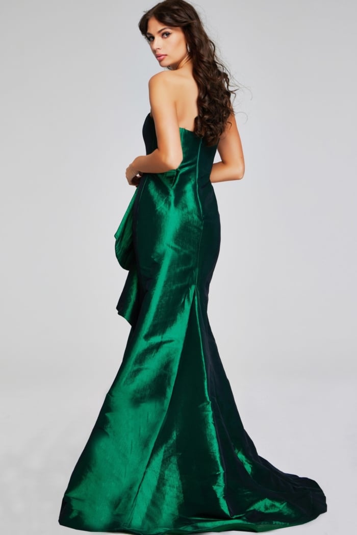 Model wearing Jovani 39368 green gown, back view showcasing mermaid silhouette.
